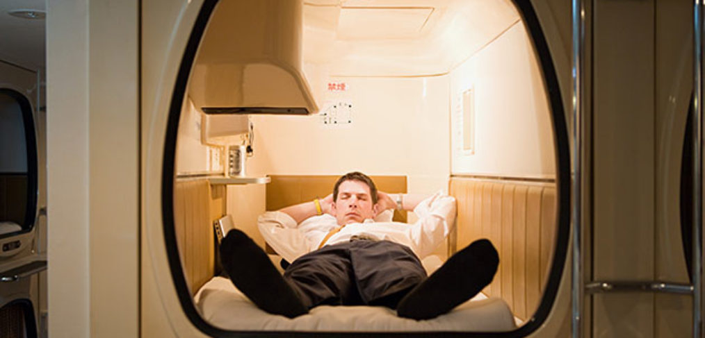 Businessman in a capsule hotel