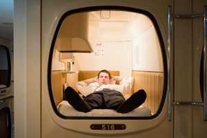 Businessman in a capsule hotel